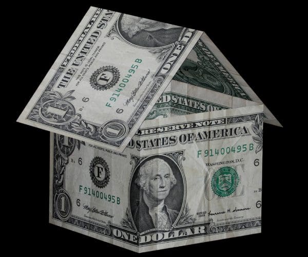 A house made of dollar bills with the roof up.