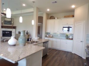 a kitchen with white cupboards and counters