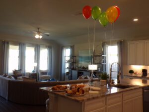 a living space and kitchen area with balloons