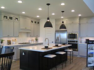 a kitchen with an island counter and barstools