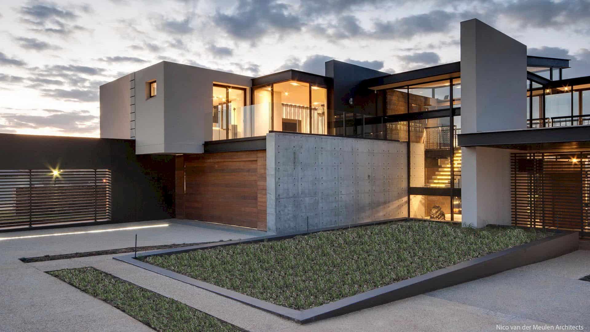 A modern house in Texas featuring large windows and a grassy yard.