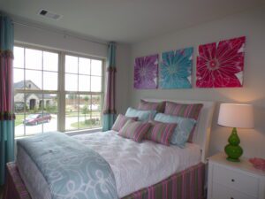 Texas builders constructed a bed with a pink and blue comforter.