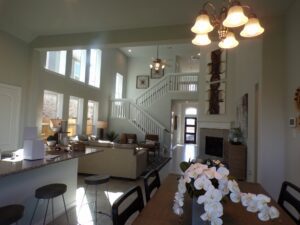 Texas builders create a stunning living room and dining room with a beautiful staircase.