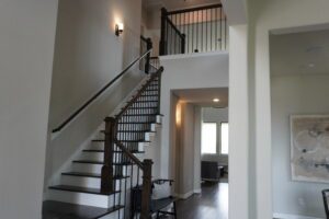 A staircase leading to a living room in a home built by Texas builders.