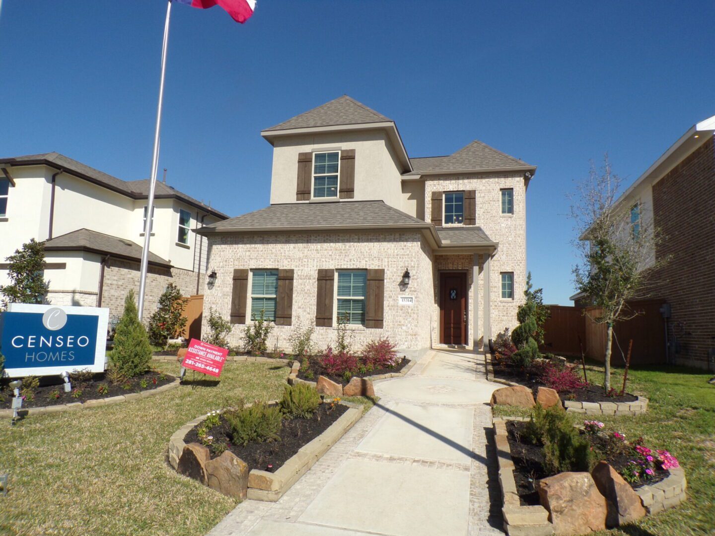 A Texas builders house with a flag in front of it.