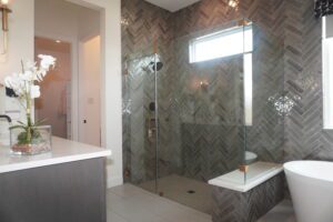 A modern bathroom with a glass shower stall, designed and constructed by skilled Texas builders.