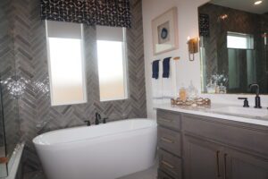         Texas builders have constructed a bathroom equipped with a bathtub, sink, and mirror.