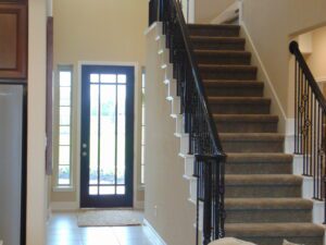 A stylish black stair railing crafted by Texas builders.