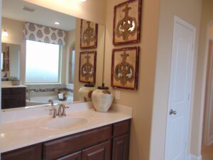 A bathroom with a sink and a mirror, built by Texas builders.