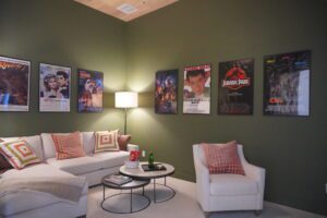 A living room decorated with movie posters on the wall, built by Texas builders.