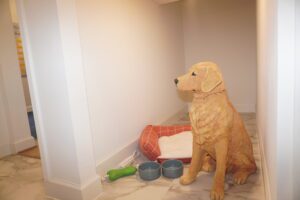 A canine statue sitting proudly in a hallway, crafted by skilled builders.