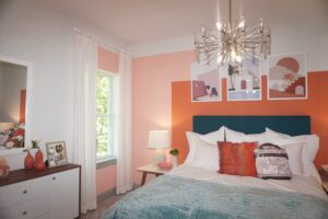 A bedroom by Texas builders with orange and blue accents.