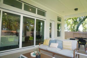 A patio with furniture and sliding glass doors built by Texas builders.