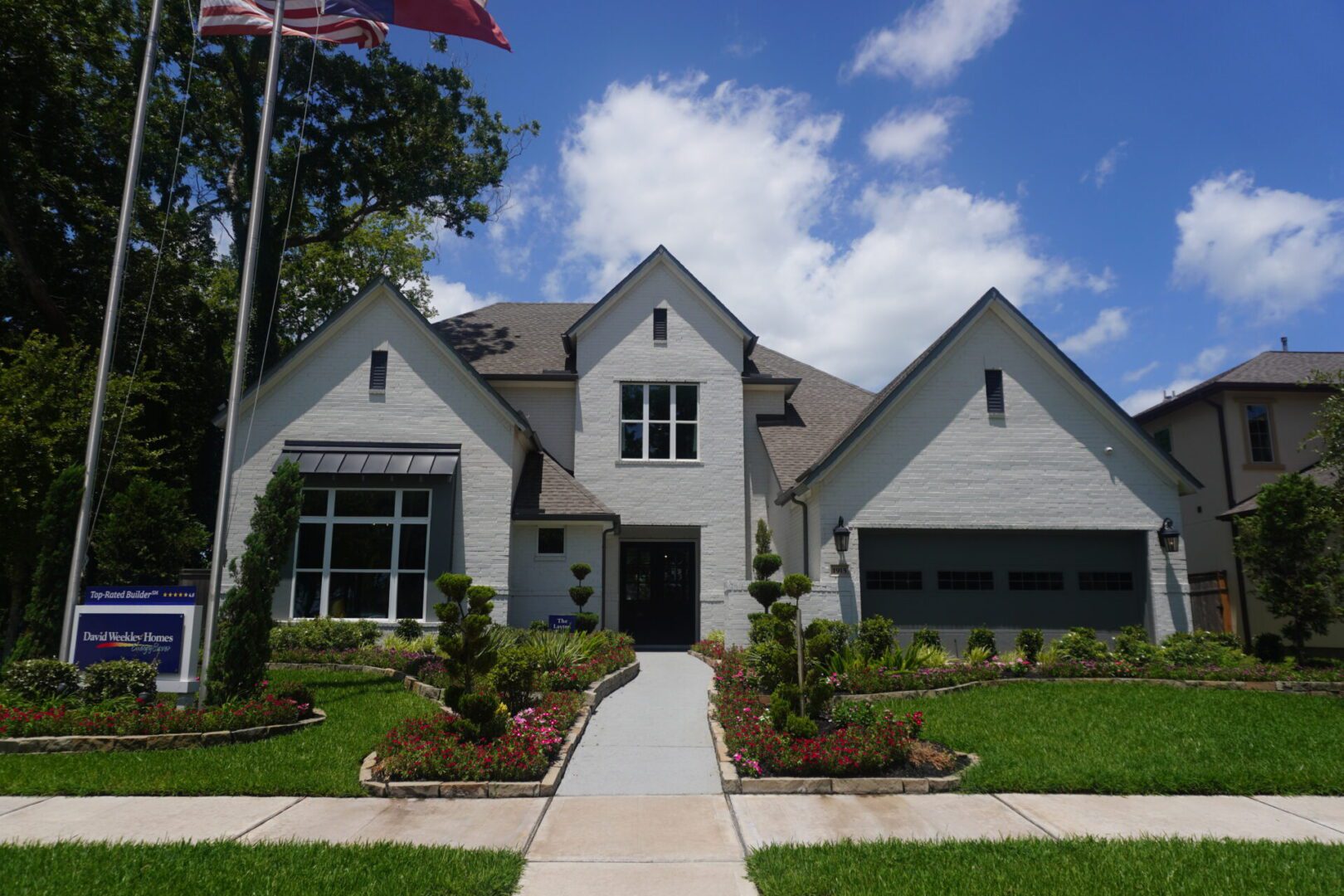 A Texas home with a flag in front of it, built by skilled builders.