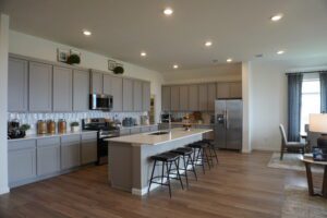 Modern kitchen with island and hardwood floors.