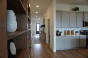 Wooden shelves with white pitcher and plate.