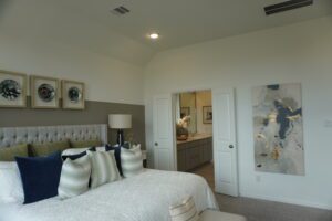 Modern bedroom with white bed and art.