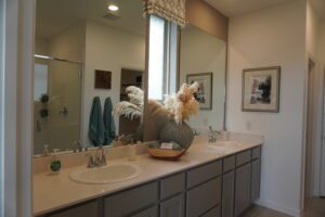 Modern bathroom with double vanity and mirror.