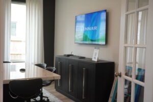 Modern office with a TV and a table.