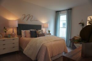 Pink and grey bedroom with a bed.