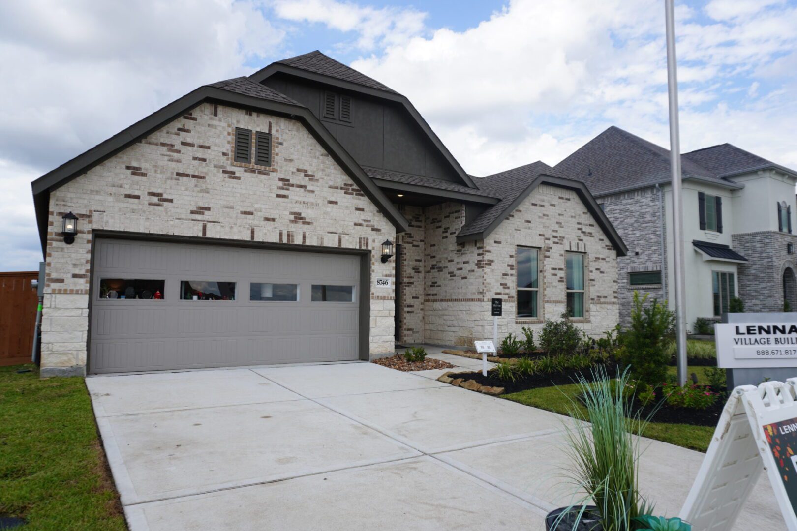 Brick house with garage and driveway.